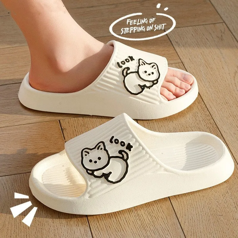 Women's pink EVA cat slippers with thick platform sole on a wooden floor.