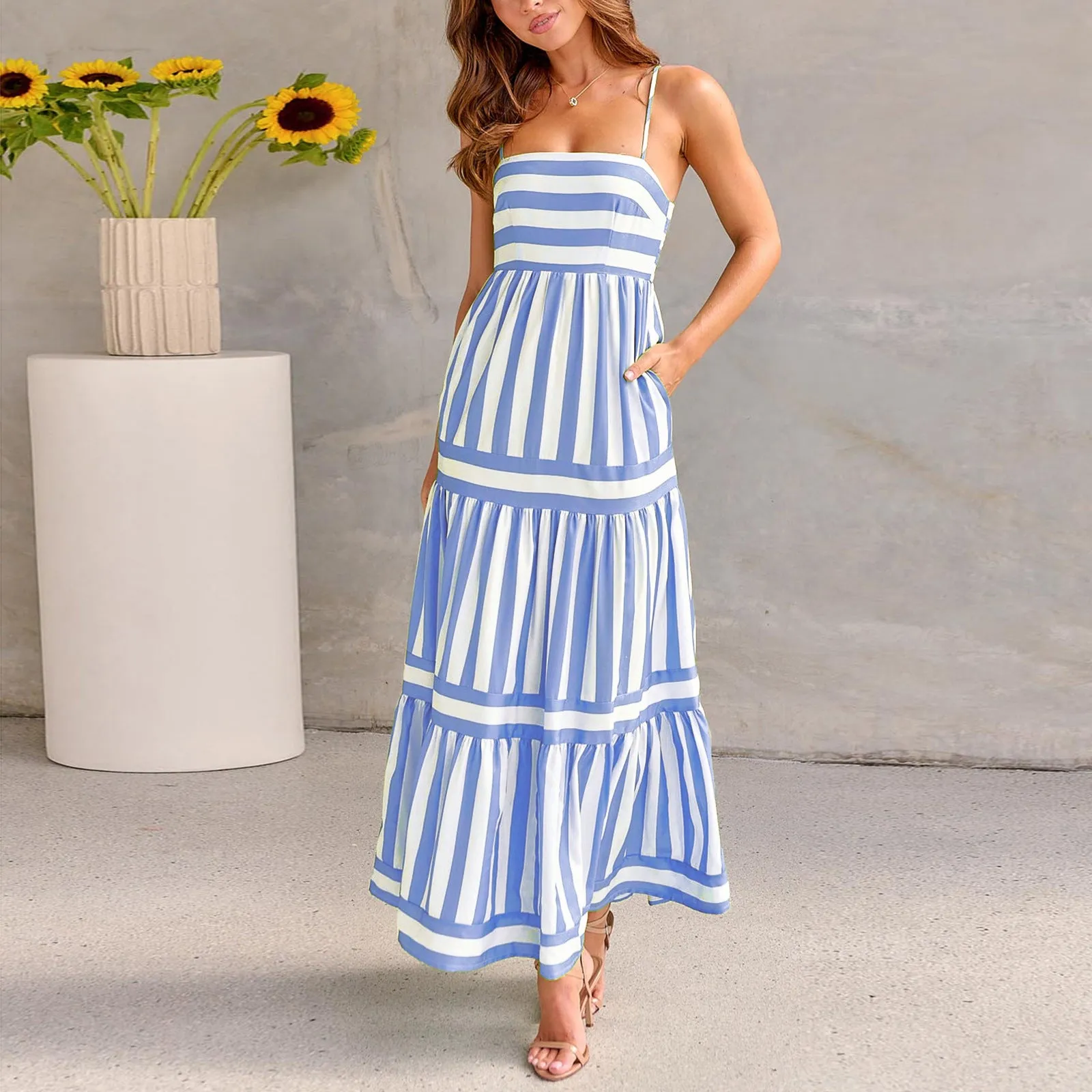 Long striped backless summer dress with square neckline and side pockets on a mannequin