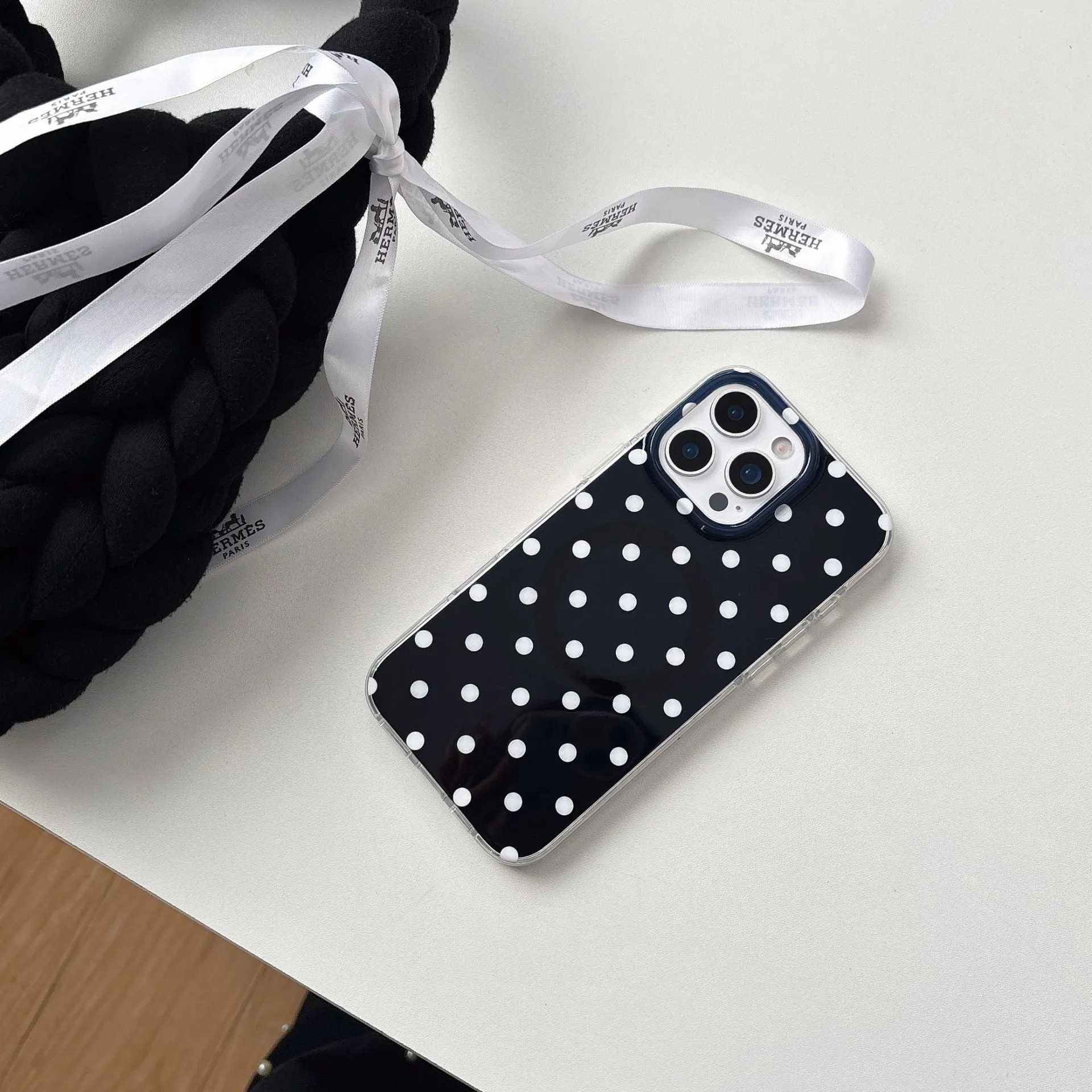 Polka dot phone case with magnetic bracket for iPhone in black showing kickstand
