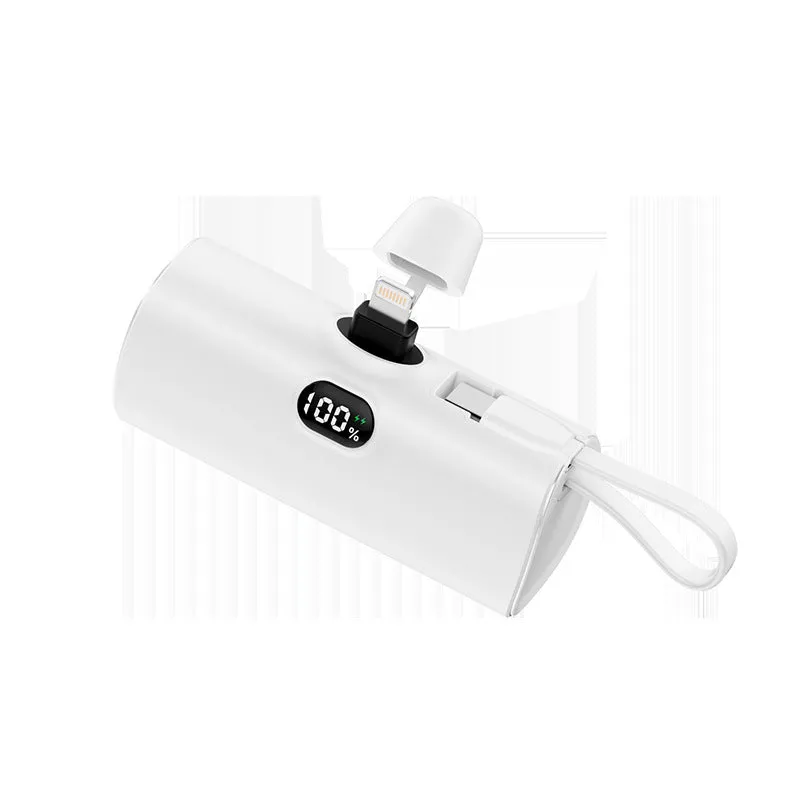 Compact black power bank with digital display and a folding AC plug extended, showing its pocket-sized dimensions.