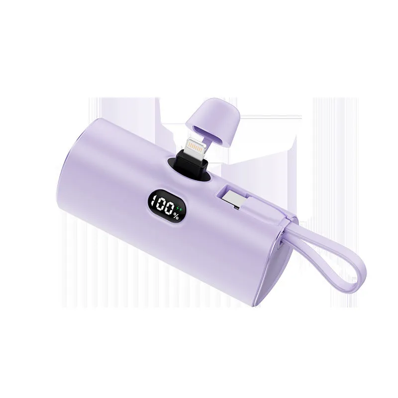 Compact black power bank with digital display and a folding AC plug extended, showing its pocket-sized dimensions.