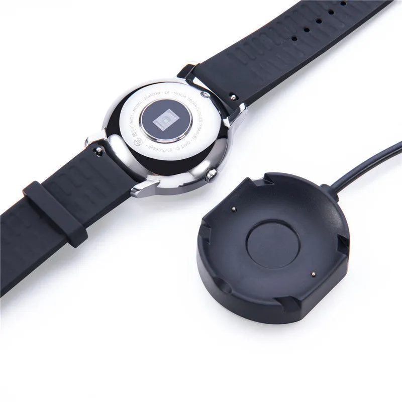 Black Withings Hybrid Smart Watch charging cable with magnetic probe on a desk