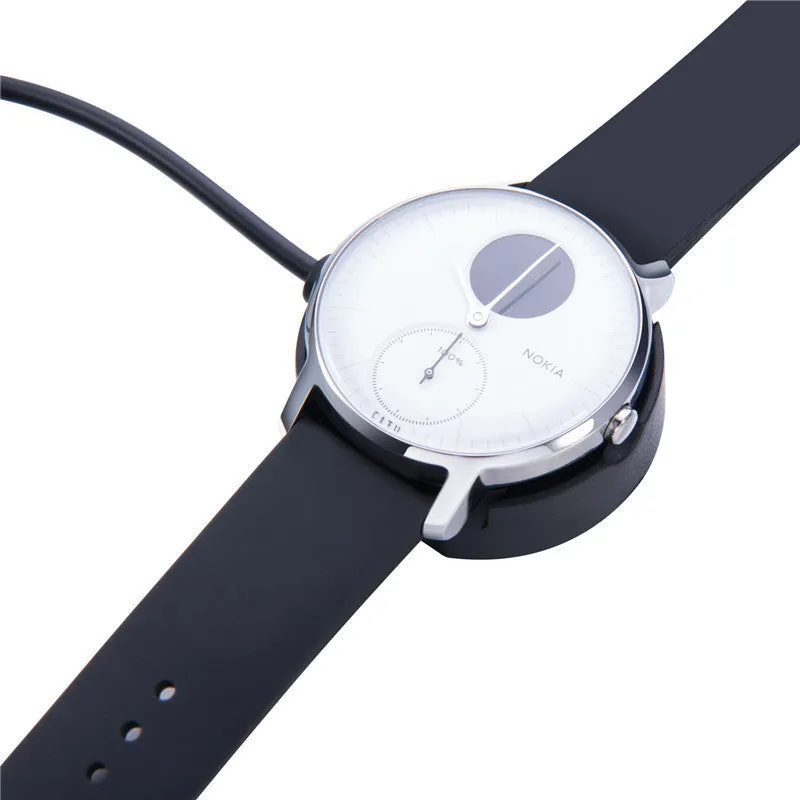 Black Withings Hybrid Smart Watch charging cable with magnetic probe on a desk