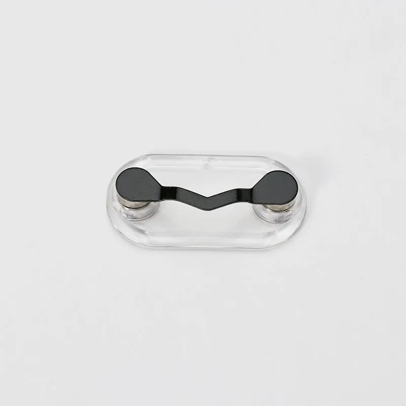 Black magnetic glasses holder on a fridge door with spectacles stored