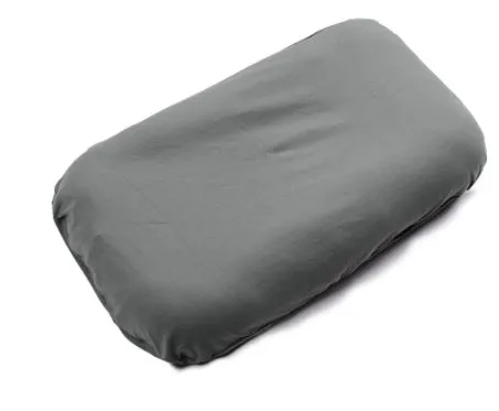 Cotton portable baby nest crib for newborns, beige colour, shown on a bed.