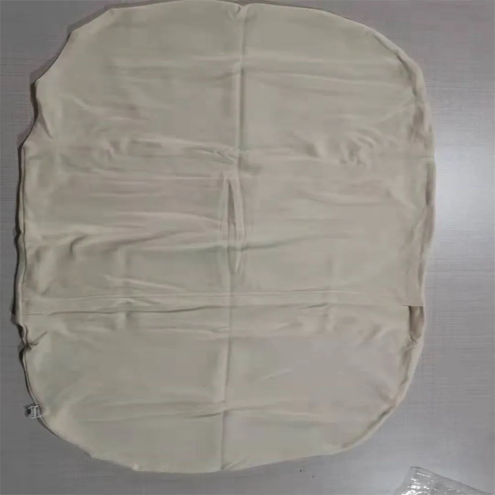 Cotton portable baby nest crib for newborns, beige colour, shown on a bed.