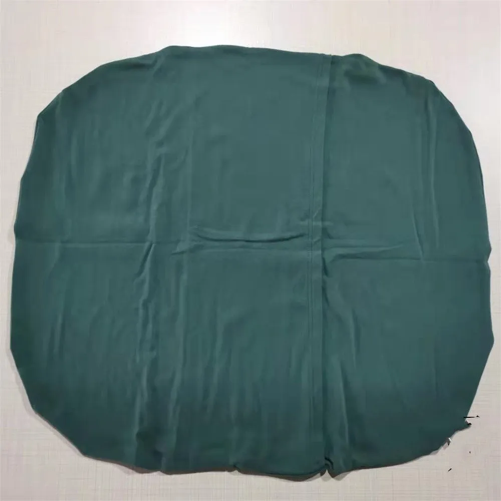 Cotton portable baby nest crib for newborns, beige colour, shown on a bed.