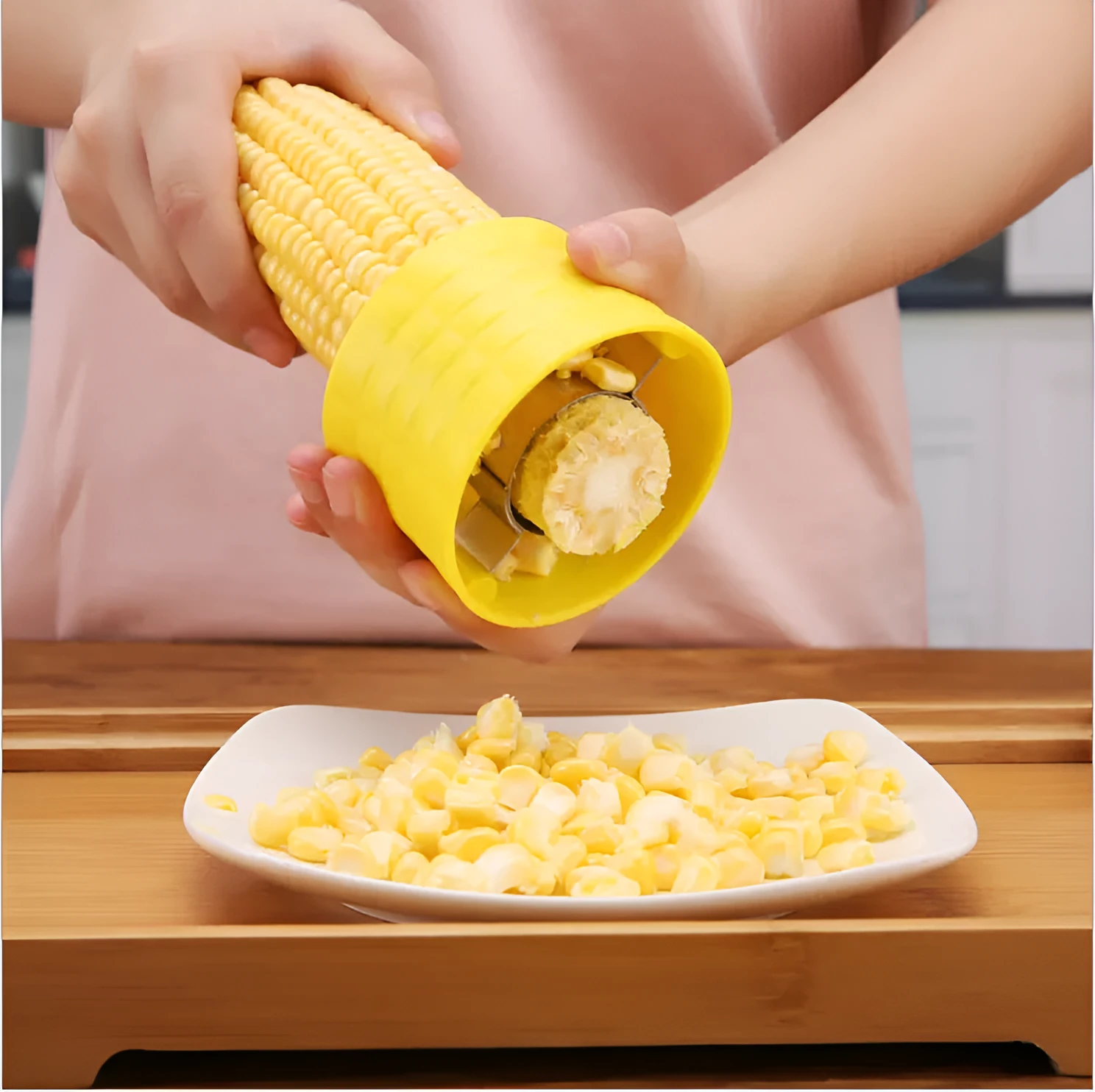 Yellow corn-shaped manual peeler thresher with a stainless steel gear for removing kernels.