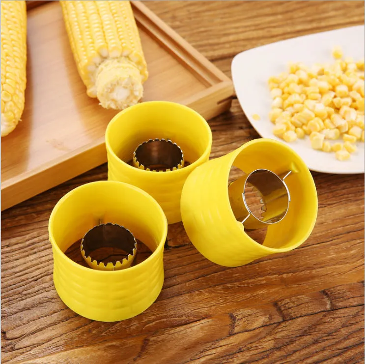 Yellow corn-shaped manual peeler thresher with a stainless steel gear for removing kernels.