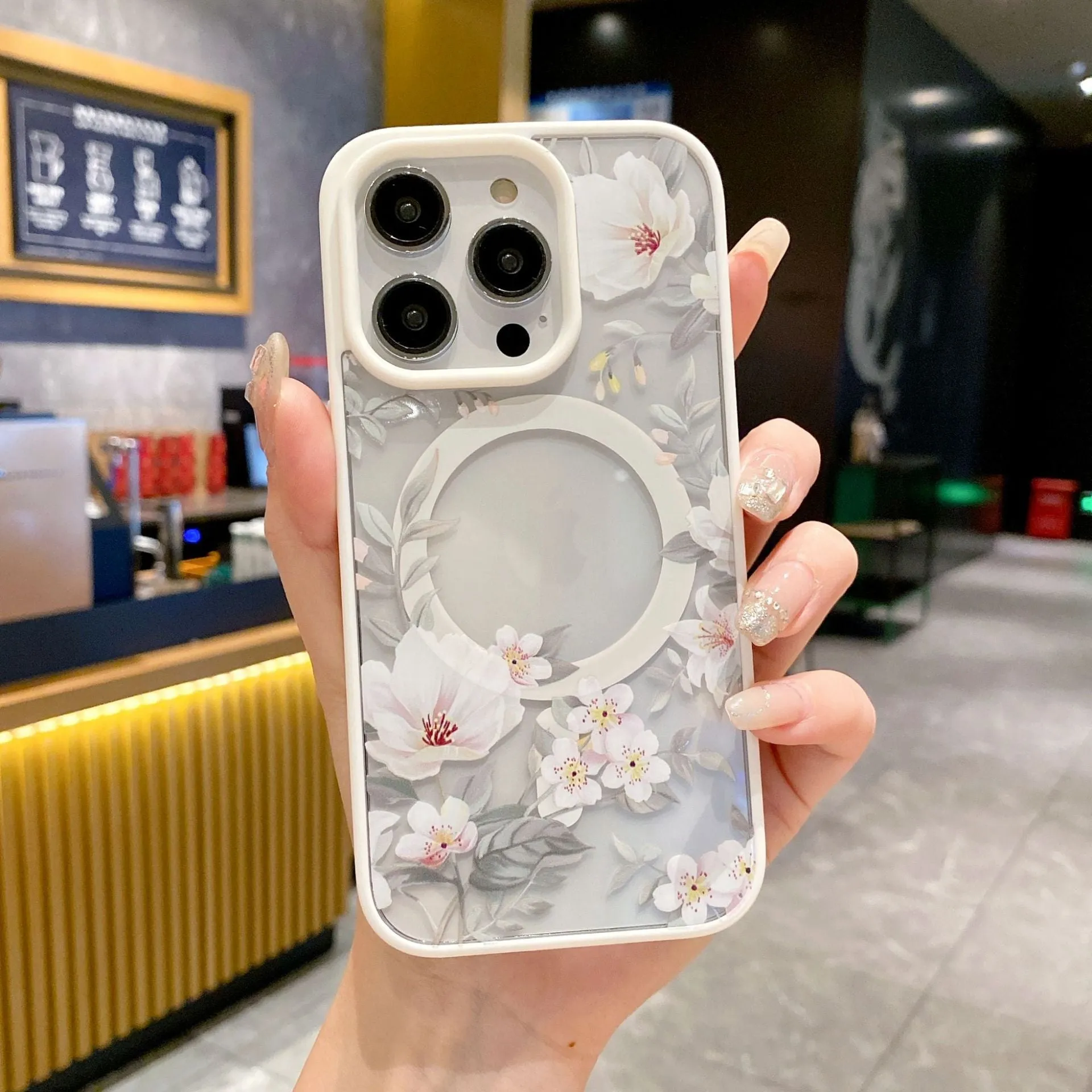 Magnetic acrylic two-in-one phone case with purple floral design on black back for iPhone