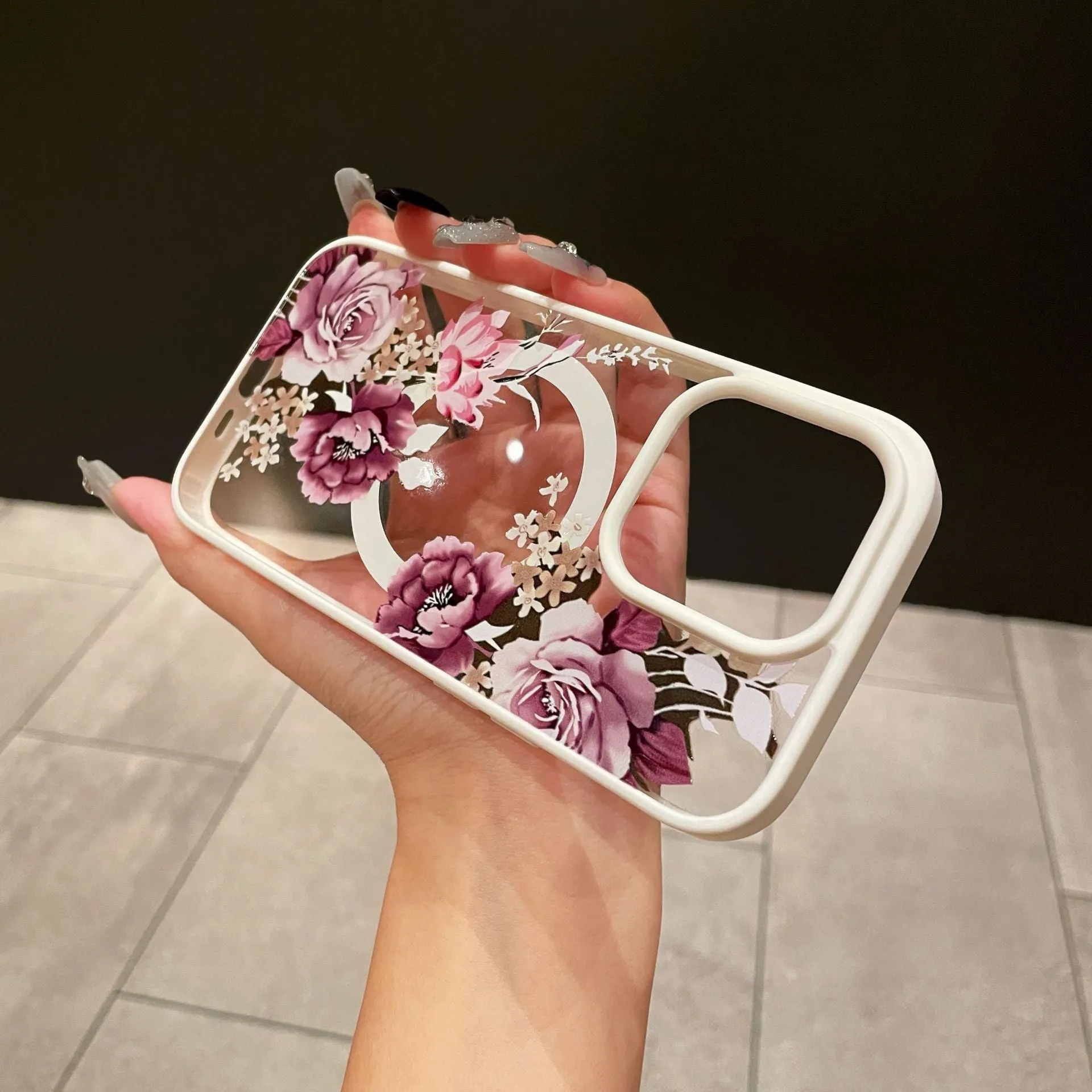 Magnetic acrylic two-in-one phone case with purple floral design on black back for iPhone