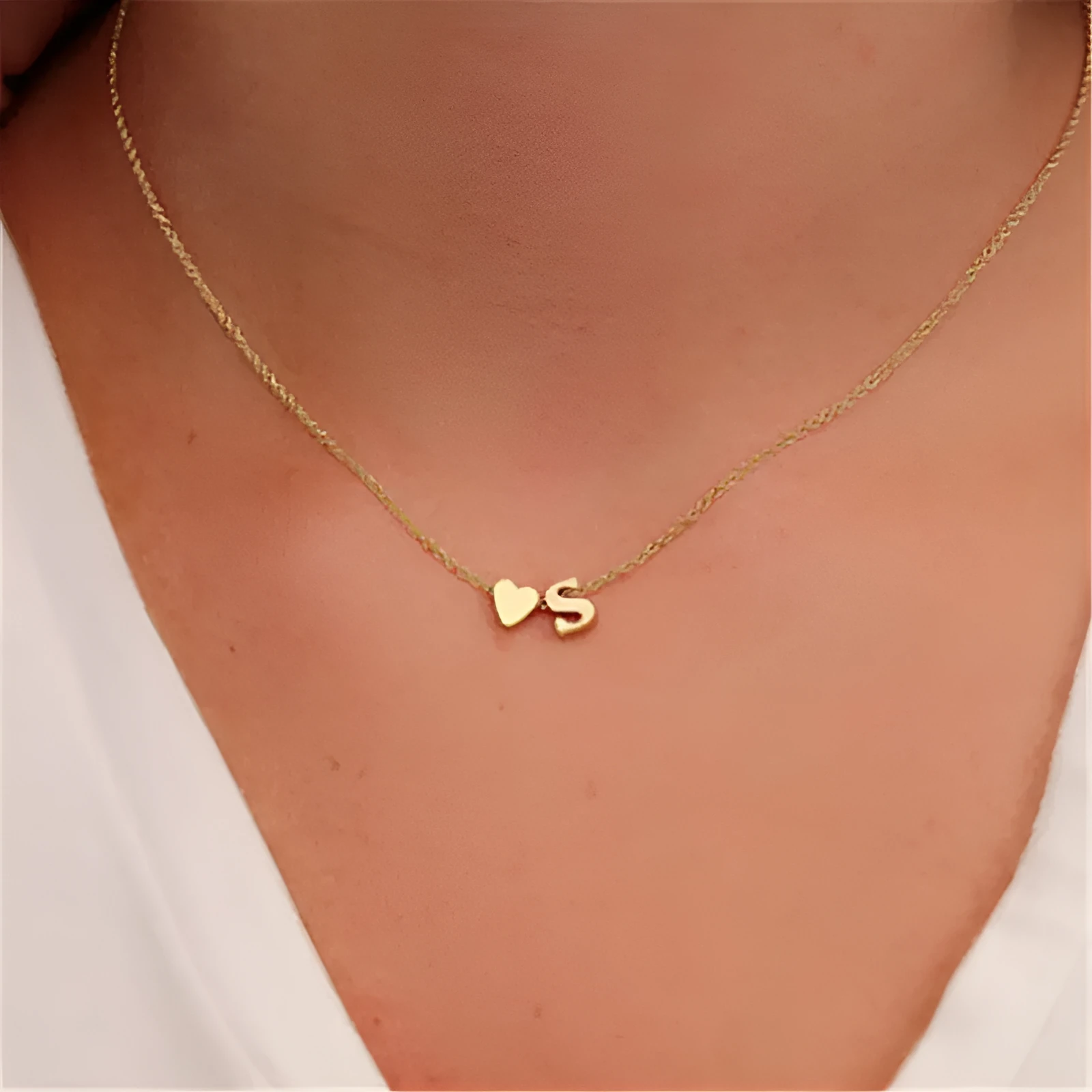 Peach heart shaped letter necklace pendant in gold or silver alloy, weighing 5.5g.