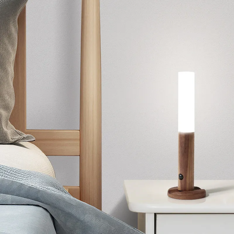 Smart sensor LED desk lamp in solid wood and acrylic, showing compact design beside a charging cable.