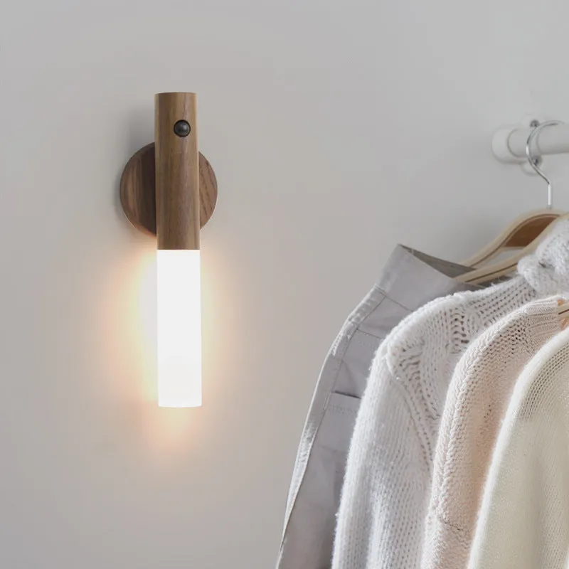 Smart sensor LED desk lamp in solid wood and acrylic, showing compact design beside a charging cable.
