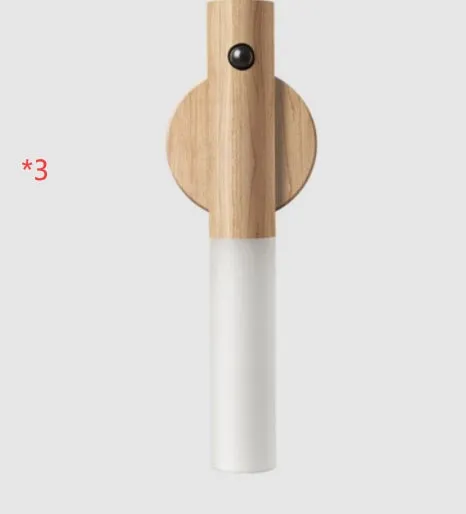 Smart sensor LED desk lamp in solid wood and acrylic, showing compact design beside a charging cable.