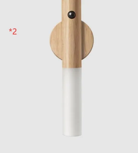 Smart sensor LED desk lamp in solid wood and acrylic, showing compact design beside a charging cable.