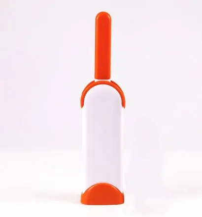 Blue reusable pet hair removal comb with double-sided sticky brush next to its self-cleaning base.