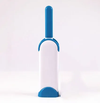 Blue reusable pet hair removal comb with double-sided sticky brush next to its self-cleaning base.