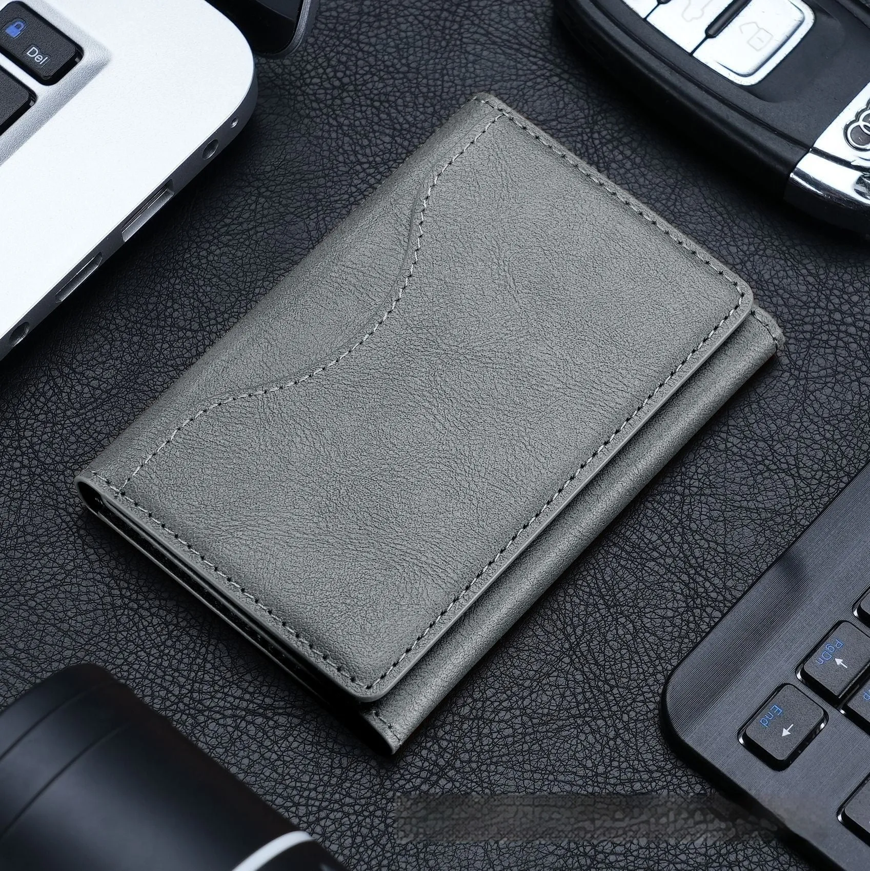 Leather tri-fold magnetic wallet card holder in black with embossed texture