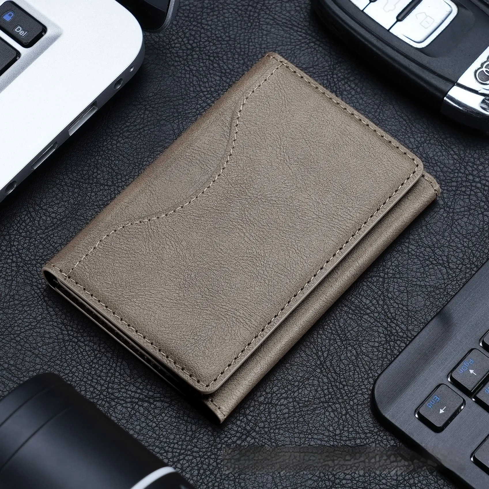 Leather tri-fold magnetic wallet card holder in black with embossed texture