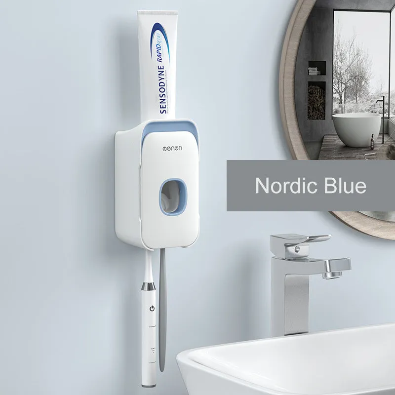 Automatic toothpaste dispenser in grey, blue, and pink colours on a bathroom countertop.