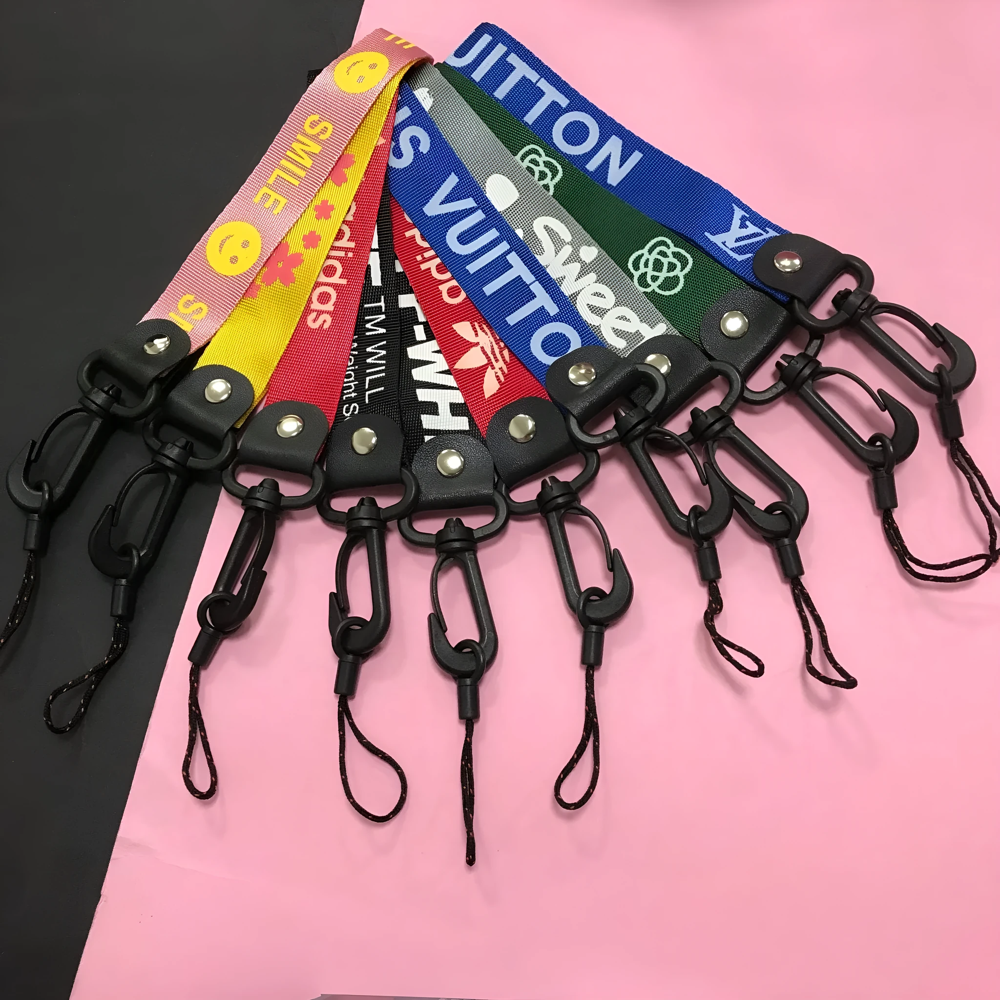 Short 25cm printed polyester mobile phone lanyard with 2-in-1 hooks in mixed colour on a wrist