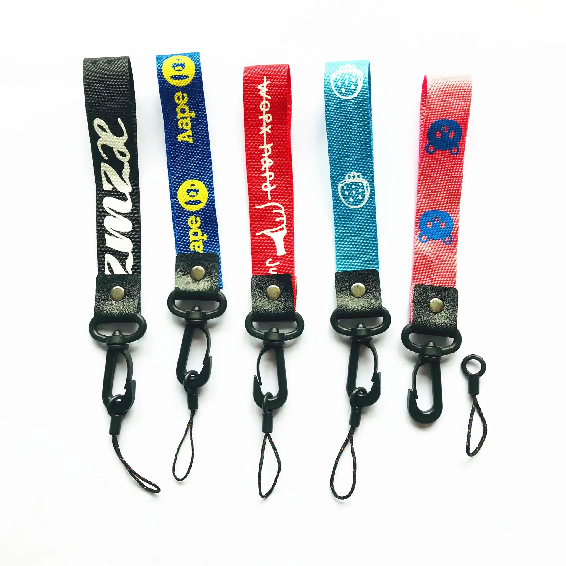 Short 25cm printed polyester mobile phone lanyard with 2-in-1 hooks in mixed colour on a wrist