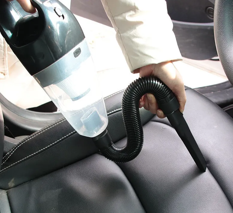 Orange 12V portable handheld car vacuum cleaner with nozzle attachments on a car seat.