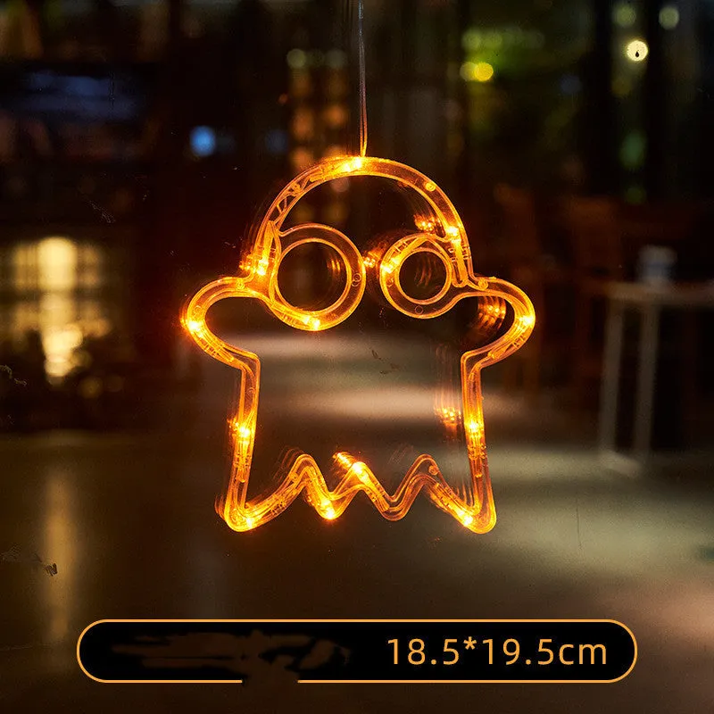 Seven Halloween LED window lights with spider, pumpkin, and ghost designs featuring suction cups for mounting