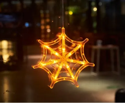 Seven Halloween LED window lights with spider, pumpkin, and ghost designs featuring suction cups for mounting