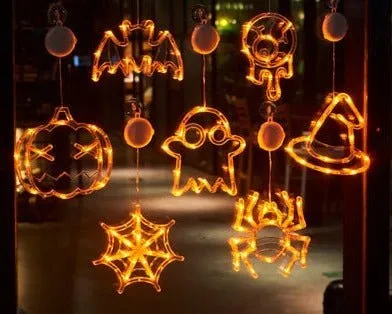 Seven Halloween LED window lights with spider, pumpkin, and ghost designs featuring suction cups for mounting