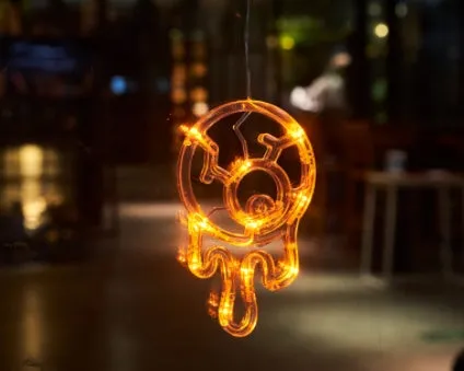 Seven Halloween LED window lights with spider, pumpkin, and ghost designs featuring suction cups for mounting