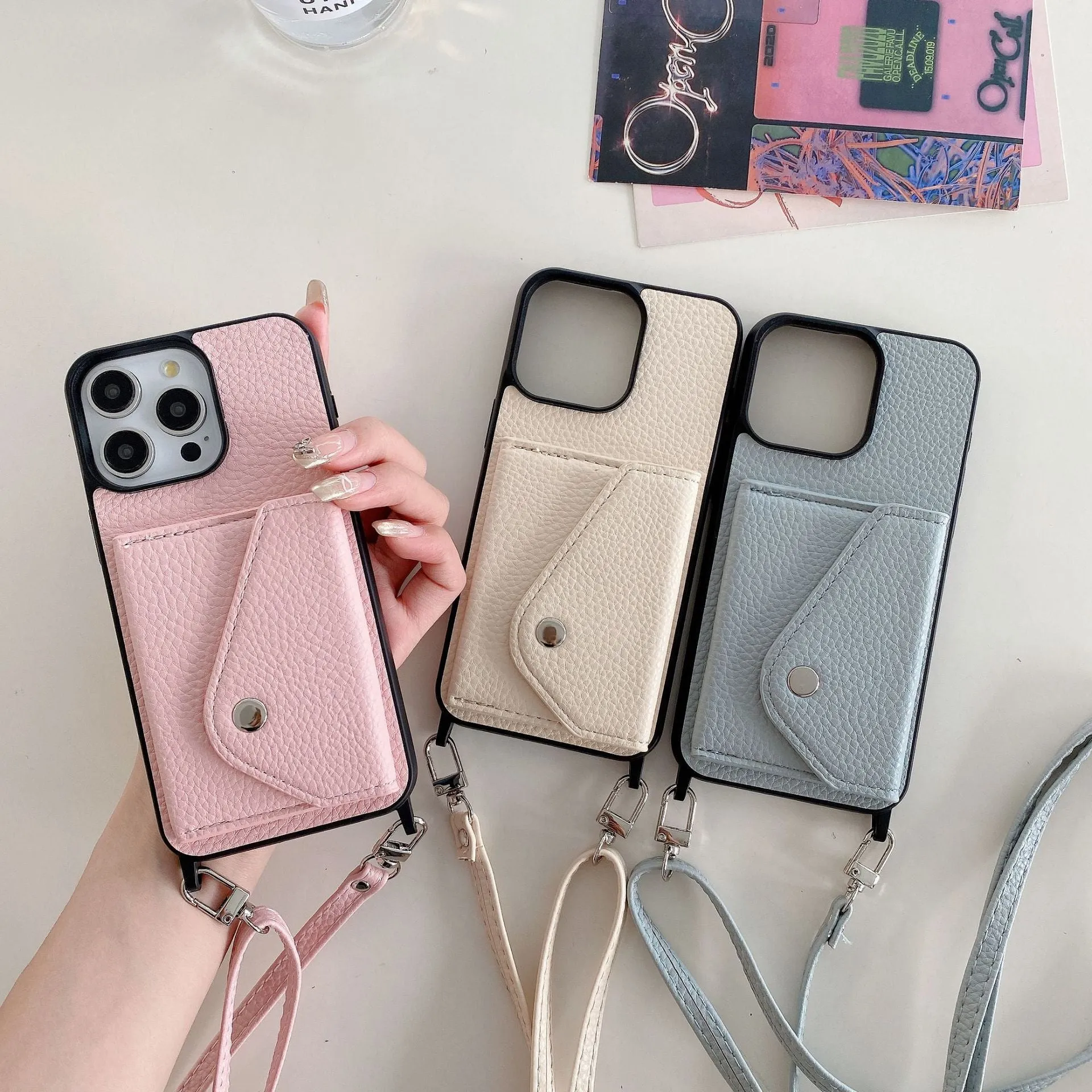 Lychee pattern imitation leather phone case with crossbody strap and triangle card holder for iPhone 14