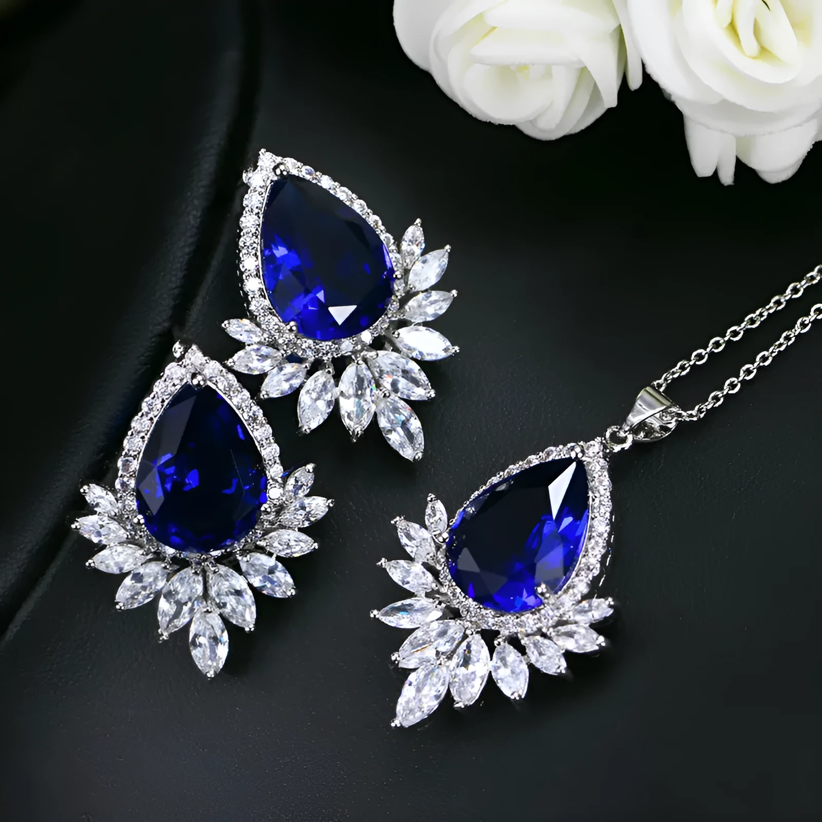 AAA formal jewellery set with chain link necklace, earrings, and pendant featuring cubic zirconia stones in blue, red, or white.