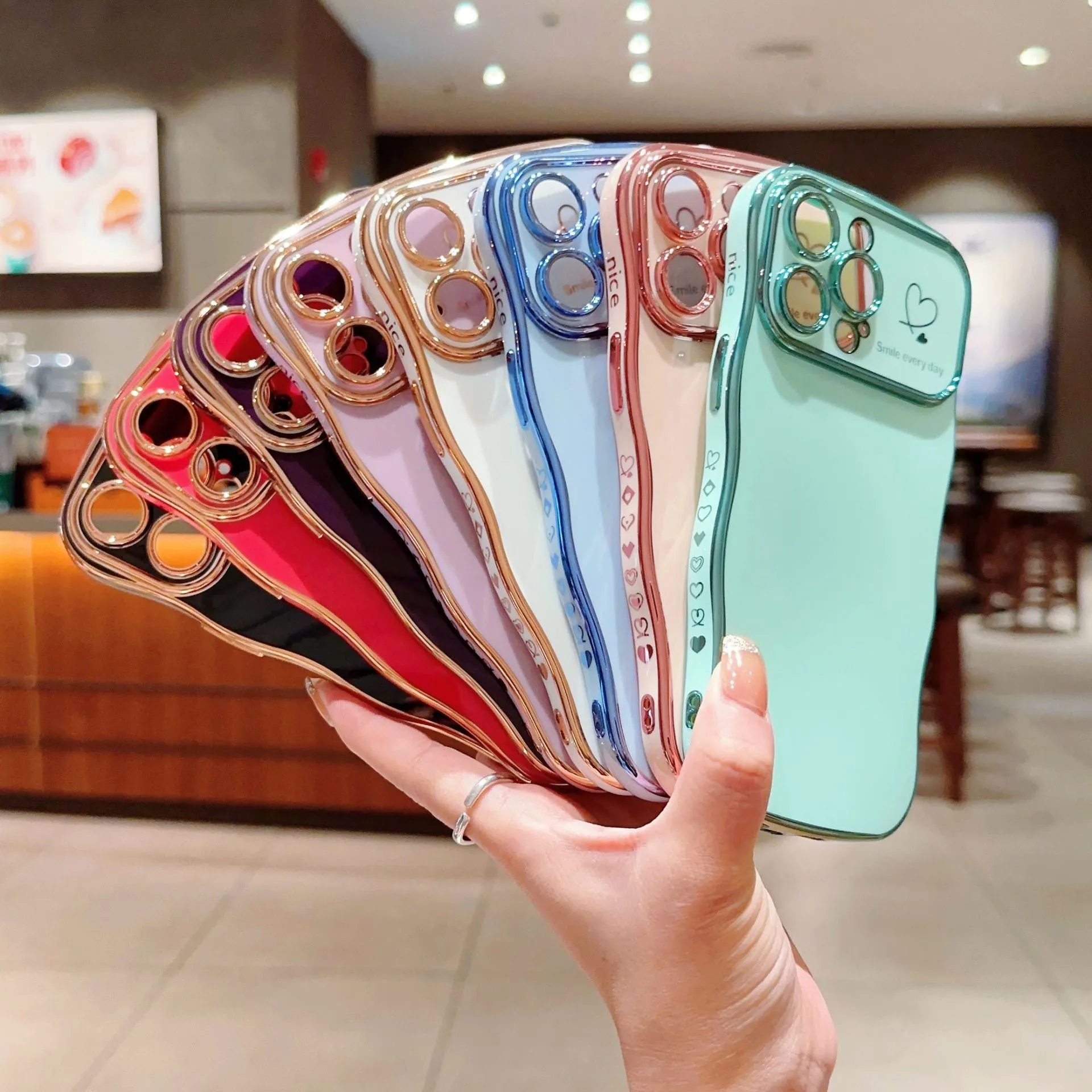 Electroplating wave love large window phone case in black, side view showing back cover and cutouts for iPhone