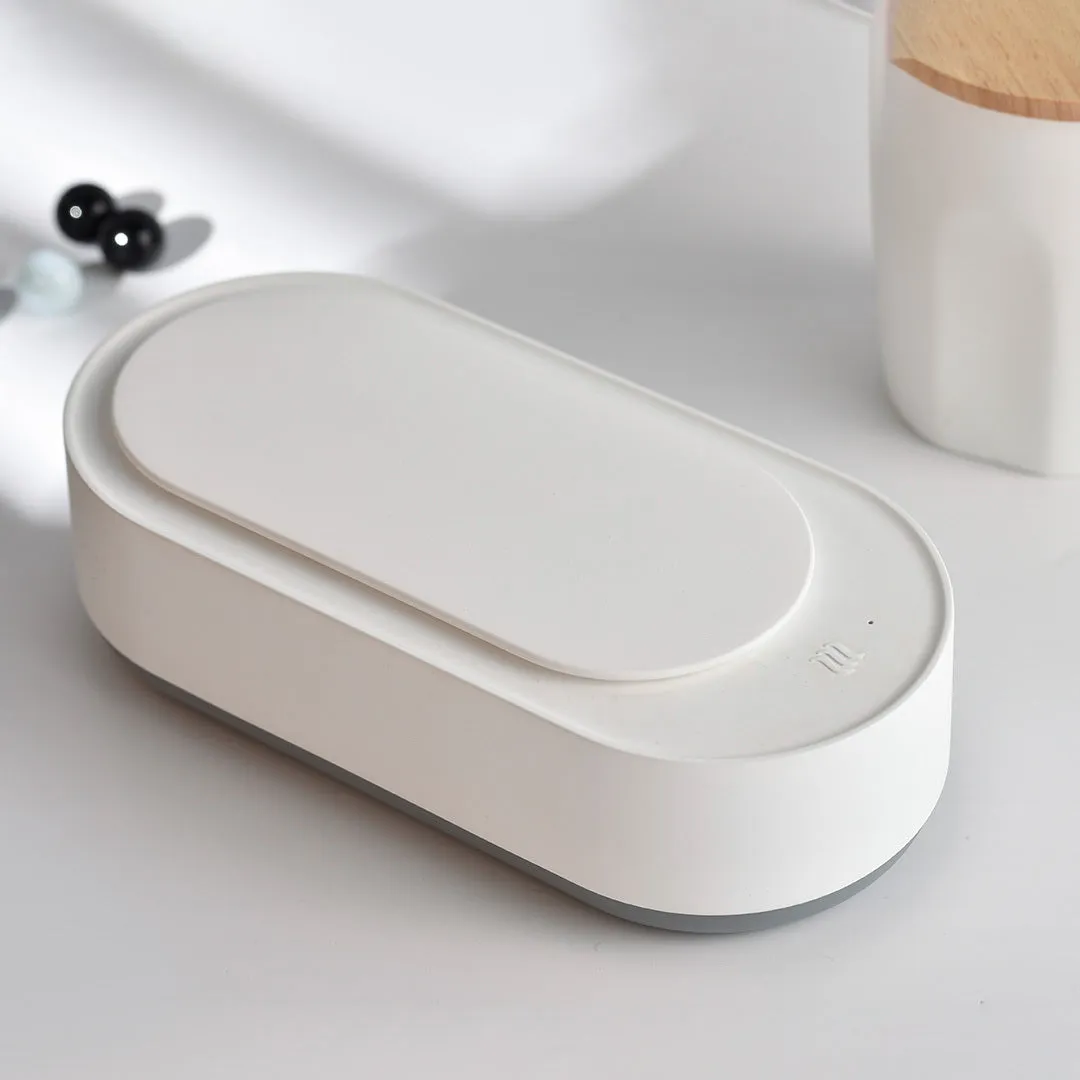 White portable ultrasonic cleaning machine with stainless steel tank and touch button.
