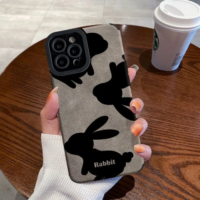 Cartoon creative TPU phone case with checkerboard bunny design on an iPhone 14, in wave black colour