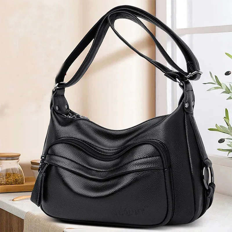 Large black women's crossbody shoulder bag with multiple internal compartments and zip closure