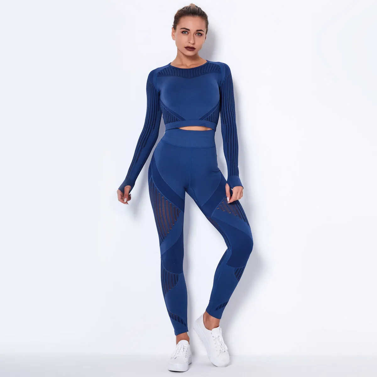 Woman wearing a seamless long-sleeved yoga suit in a neutral colour, demonstrating a stretch pose.