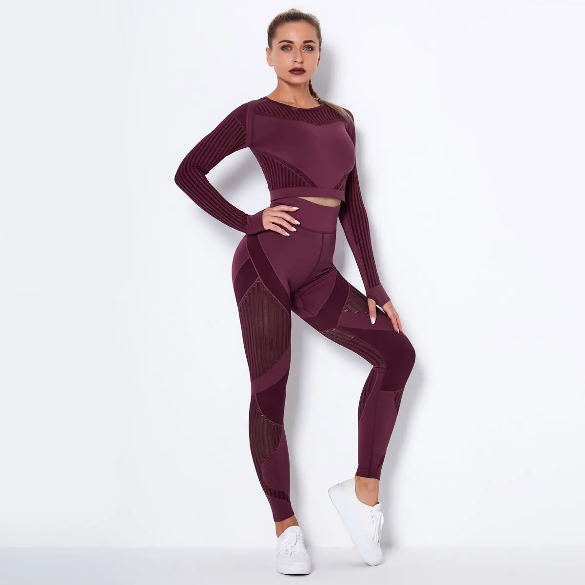 Woman wearing a seamless long-sleeved yoga suit in a neutral colour, demonstrating a stretch pose.