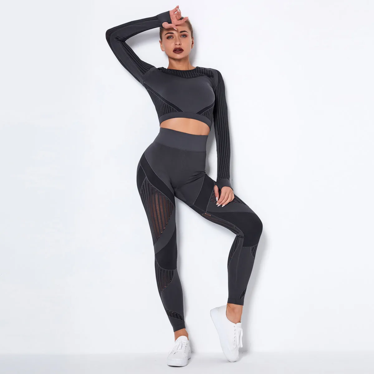 Woman wearing a seamless long-sleeved yoga suit in a neutral colour, demonstrating a stretch pose.