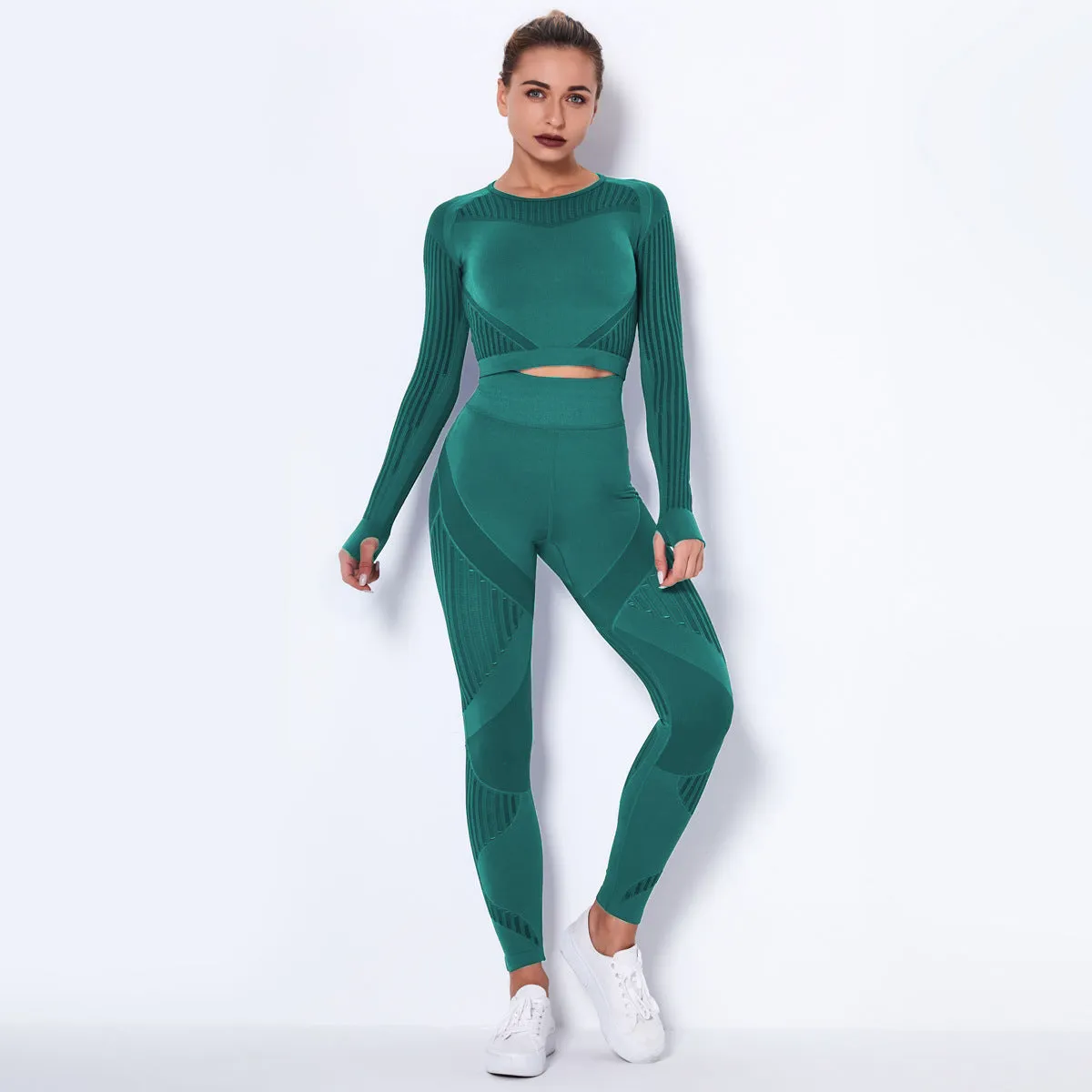 Woman wearing a seamless long-sleeved yoga suit in a neutral colour, demonstrating a stretch pose.
