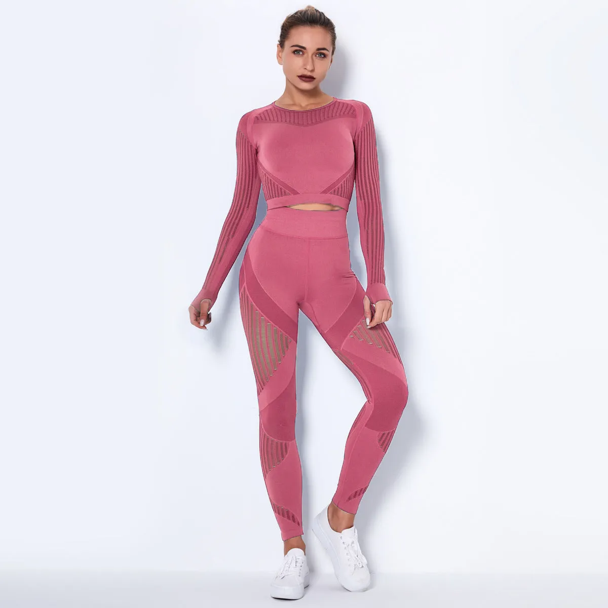 Woman wearing a seamless long-sleeved yoga suit in a neutral colour, demonstrating a stretch pose.