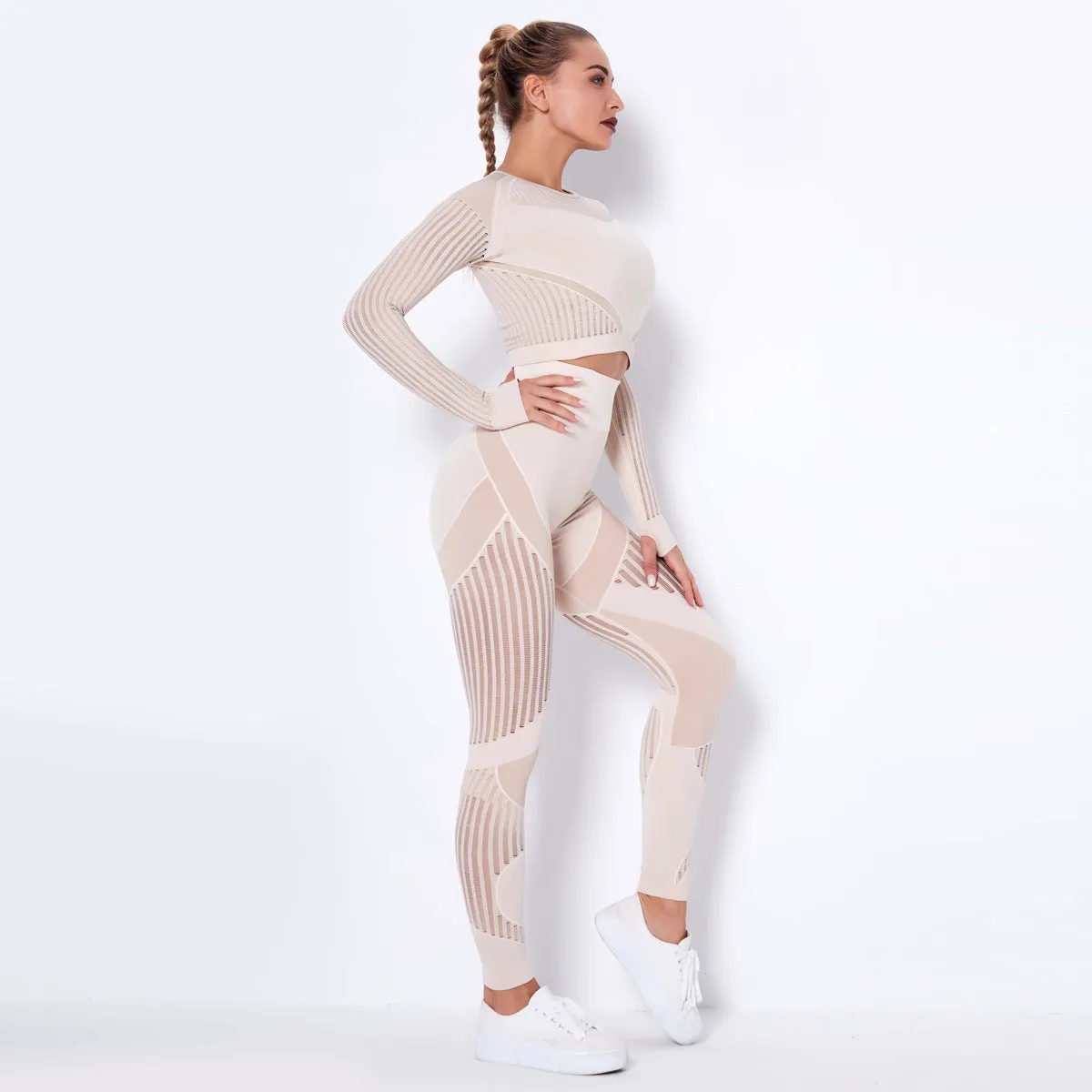 Woman wearing a seamless long-sleeved yoga suit in a neutral colour, demonstrating a stretch pose.