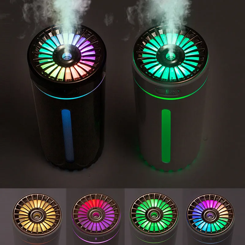 Black portable USB rechargeable humidifier with colourful LED lights on a car cup holder.
