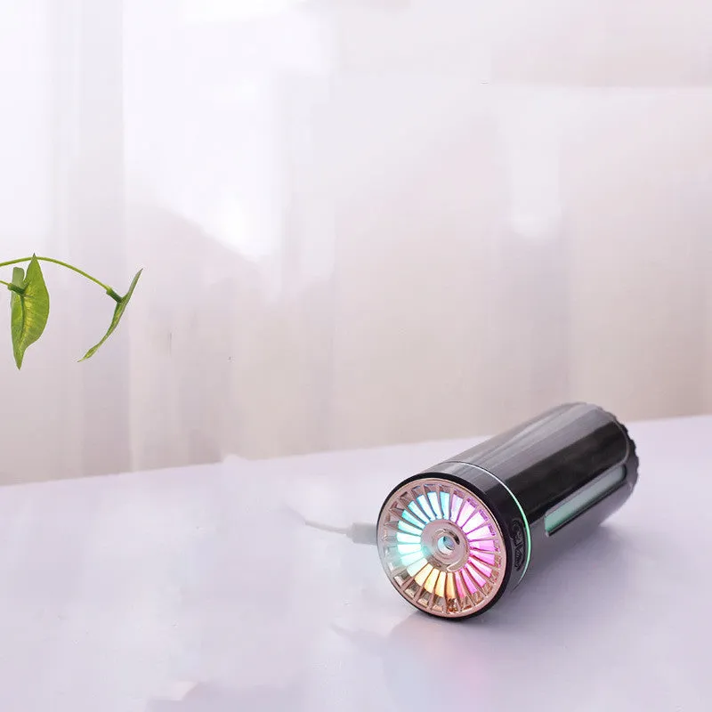 Black portable USB rechargeable humidifier with colourful LED lights on a car cup holder.