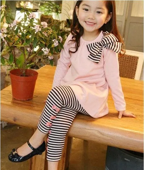 Pink cotton clothing set for girls on a hanger, showing short sleeves.