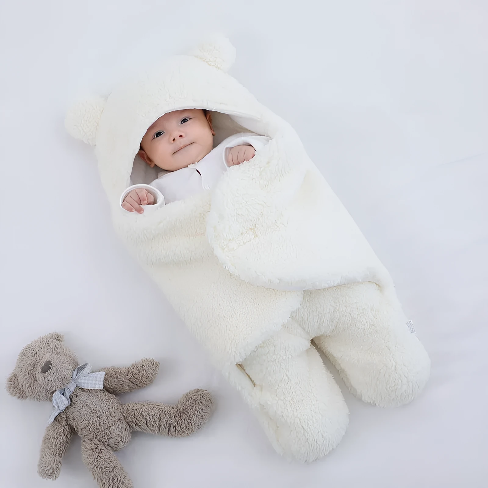 Baby quilted sleeping bag wrapper in cotton blend fabric, shown in a light blue colour.