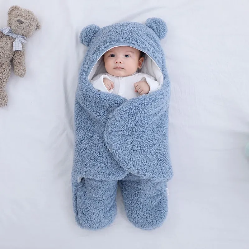 Baby quilted sleeping bag wrapper in cotton blend fabric, shown in a light blue colour.