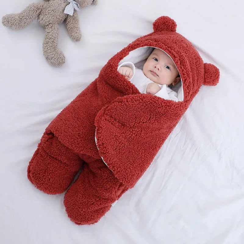 Baby quilted sleeping bag wrapper in cotton blend fabric, shown in a light blue colour.
